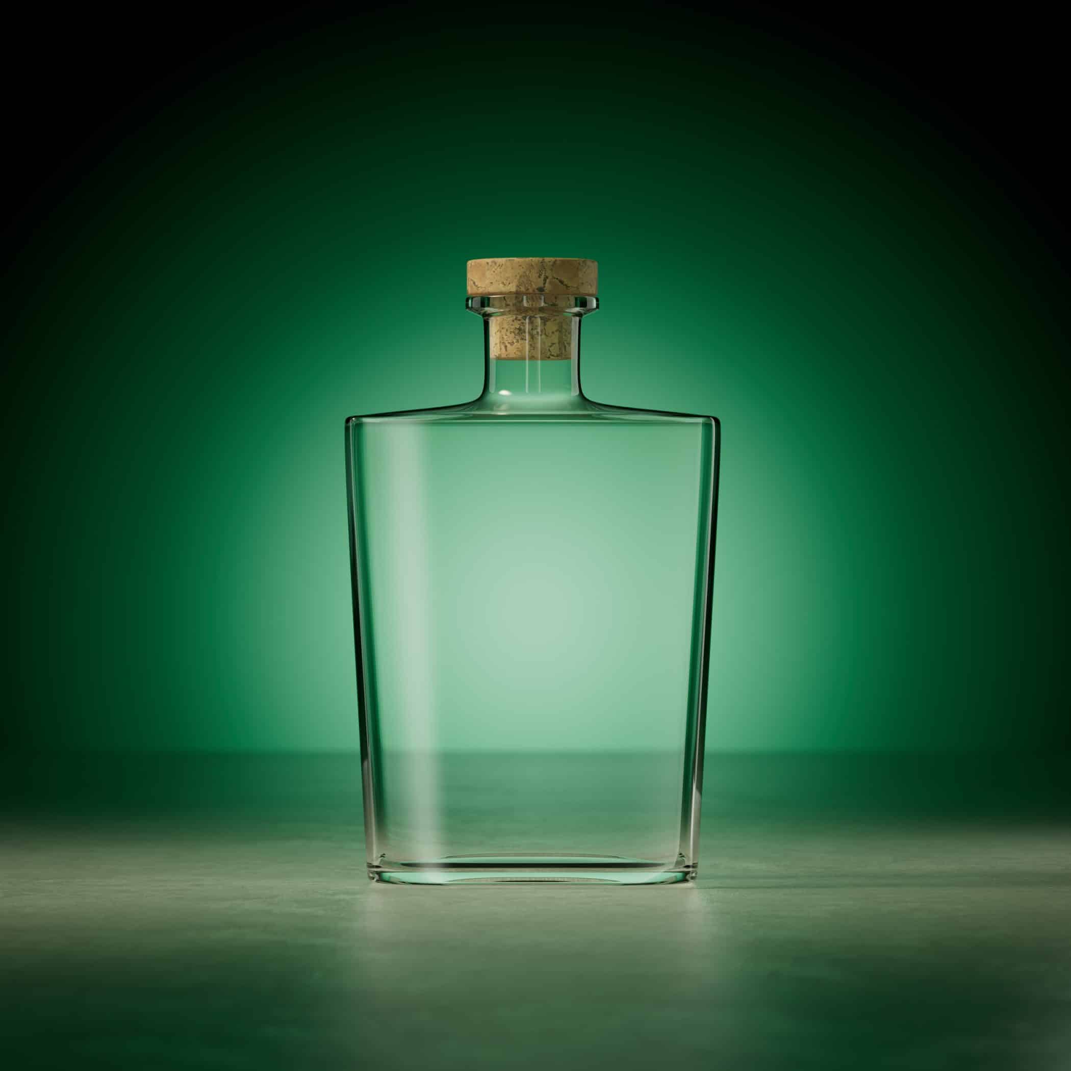 A clear, square glass bottle with cork bartop sealing it. Sat in front of a green background. lit by a spotlight.